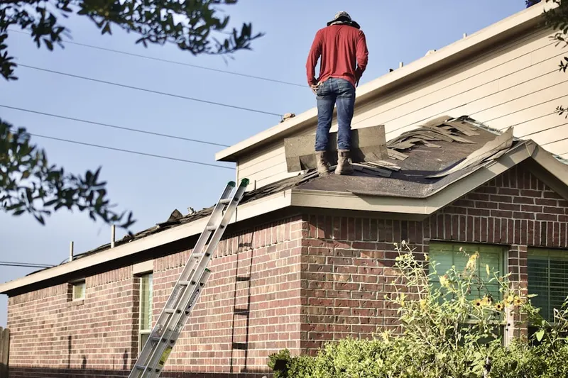 Professional roofer working on a residential roof in Pawling
